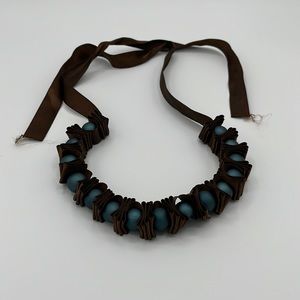 Brown ribbon necklace with blue beads